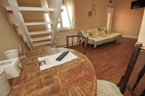 a room with a table with a remote control on it at Guest House Romantika Panzio in Gyula
