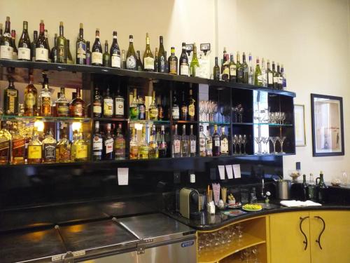 a bar filled with lots of bottles of alcohol at Hotel Solaris in São Miguel dʼOeste