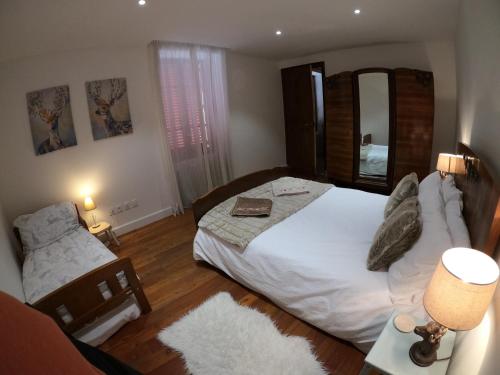 a bedroom with a large bed and a mirror at Chez Daisy in Longefoy