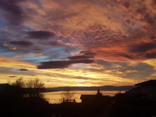 a sunset over a body of water at Montreux Holiday Home in Montreux