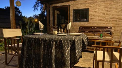 a table with a black table cloth on a patio at Ruda Lodge Exclusive Bed & Breakfast in General Rodríguez
