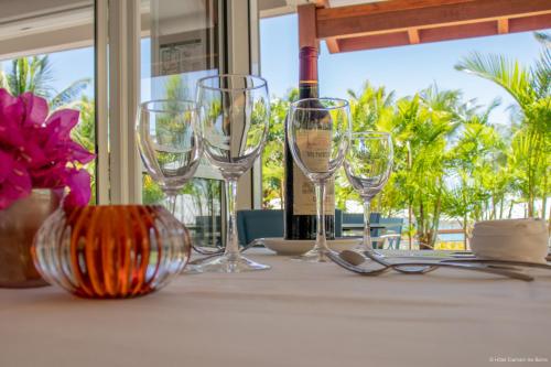 a table with wine glasses sitting on top of it at Diamant les bains - Résidence Hôtelière in Le Diamant