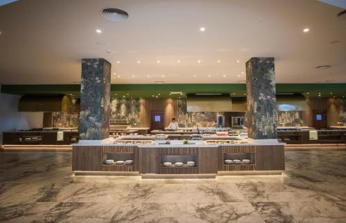 a restaurant with a buffet in the middle of a building at Majestic Elegance Costa Mujeres - All Inclusive in Cancún