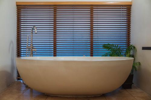 a bath tub in a bathroom with a large window at The Lazy Fish in Cockermouth