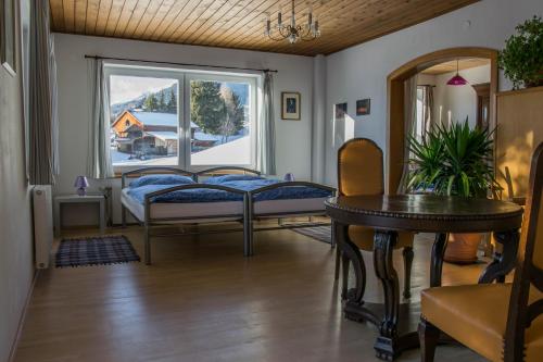a room with three beds and a window at Ferienwohnung Keseberg in Lienz