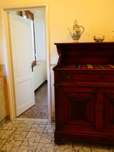 a room with a wooden dresser and a door at Casa storica e confortevole in Empoli