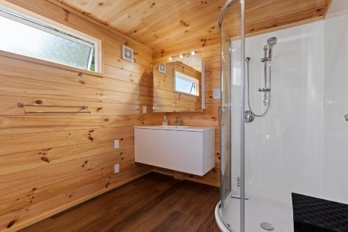 a bathroom with a shower and a sink at Matapouri Bayside Retreat - Matapouri Holiday Home in Matapouri