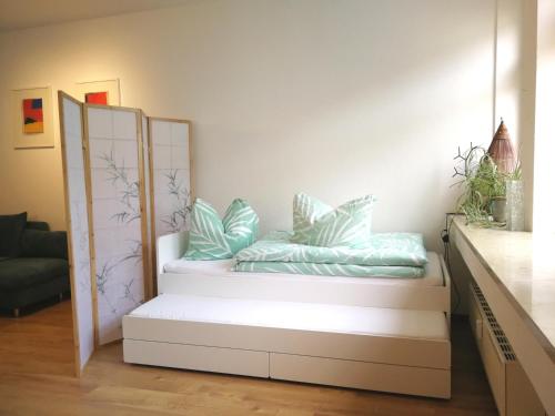 a room with a bench with pillows on it at Apt next to Nuremberg central-station, Fair 10min in Nuremberg