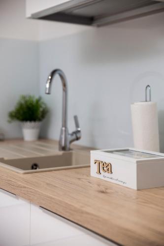 a tea box sitting on top of a kitchen counter at Apartment Opa Gold in Rijeka