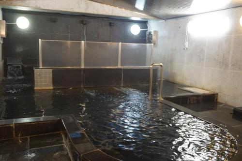 a large pool of water in a room at The Gran Resort Elegante Atami in Atami