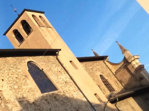 a church steeple with a tower on top of it at Hotel Select in Montecchio Emilia