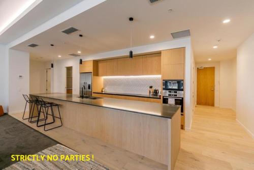 a large kitchen with a counter top in a room at Acrossia Apartment Suites in Auckland