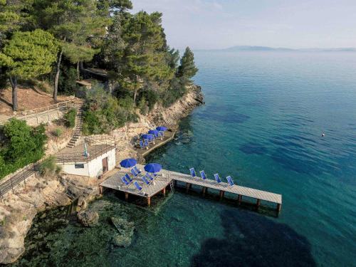 an aerial view of a dock with chairs and the water at Albergo Filippo II in Porto Santo Stefano