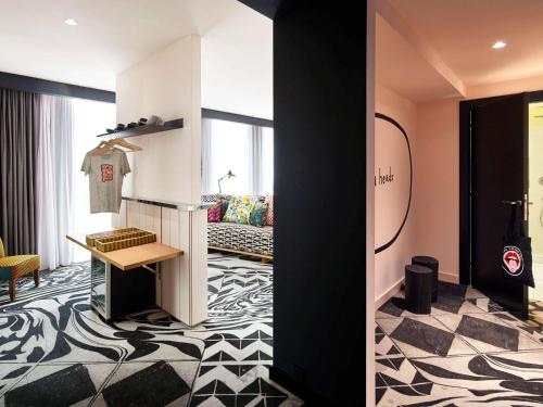 a room with a room with a couch and a room with a floor at Mama Shelter Belgrade in Belgrade