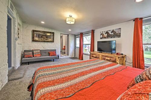 a bedroom with a bed and a flat screen tv at Retro Updated Blanco Abode - Steps to Main Street! in Blanco