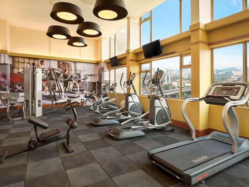 a gym with several treadmills and elliptical machines at ibis Kuala Lumpur City Centre in Kuala Lumpur