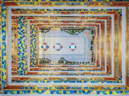 a quilt of a kitchen with two dishes on a wall at Novotel Vijayawada Varun in Vijayawāda