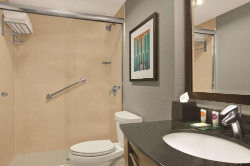 a bathroom with a toilet and a sink and a shower at Hyatt Place New York/Midtown-South in New York