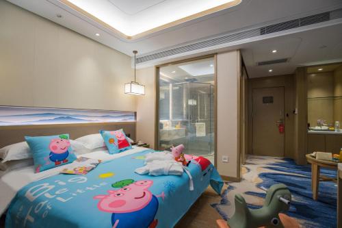 a bedroom with a bed with hello kitty pillows at Kunming Golden Spring Hotel in Kunming