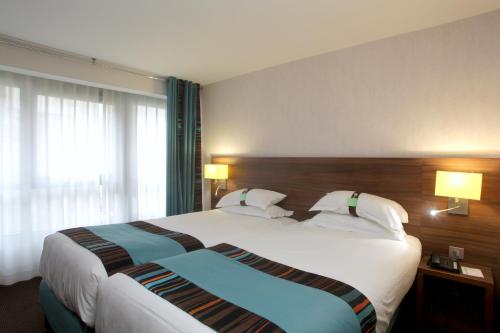 Postel nebo postele na pokoji v ubytování Holiday Inn Paris Montmartre by IHG