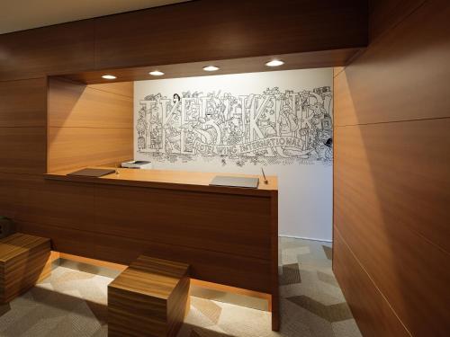 a room with a wall with a drawing on the wall at Hotel Wing International Ikebukuro in Tokyo