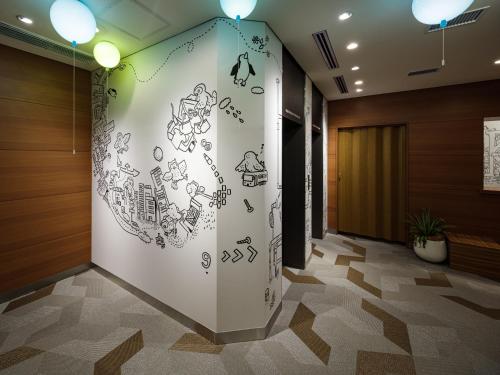 a lobby with a wall with writing on it at Hotel Wing International Ikebukuro in Tokyo