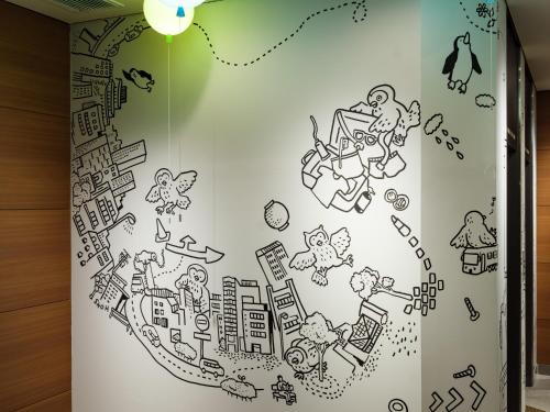 a wall in a room with a drawing of a city at Hotel Wing International Ikebukuro in Tokyo