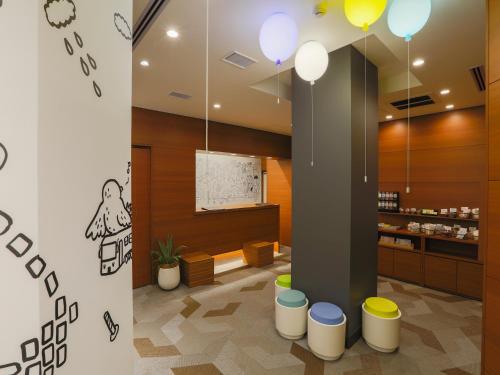 a lobby of a restaurant with stools at Hotel Wing International Ikebukuro in Tokyo
