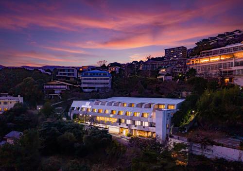 a building with lights on in a city at night at The Gran Resort Elegante Atami in Atami