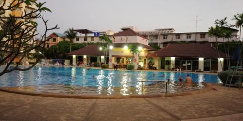 a large swimming pool with people in the water at View Talay 1B by Fernando in Pattaya South