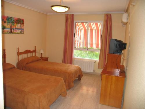 Postel nebo postele na pokoji v ubytování Hostal Imperial