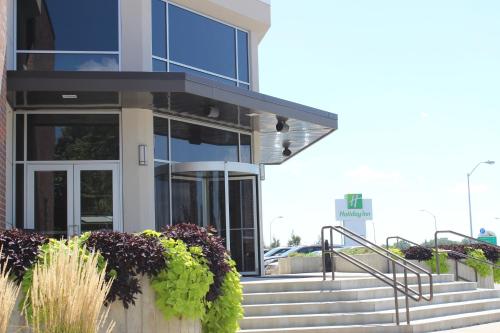 a building with stairs in front of it at Holiday Inn Des Moines-Airport Conf Center by IHG in Des Moines