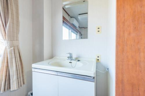 a bathroom with a sink and a mirror at Chojuyu Hakone in Hakone