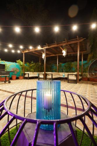 a blue glass sitting on a table in a patio at Aureole Mrida - A Boutique Hotel in Lonavala