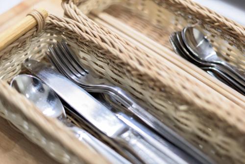 a basket with forks and spoons and a knife and fork at SALON Shibuya in Tokyo