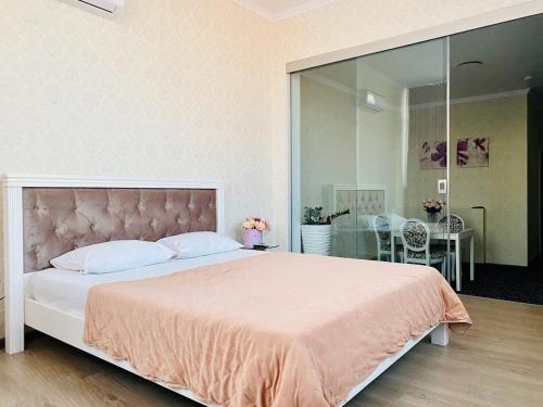 a bedroom with a large bed with a large mirror at ArkPalmira in Odesa