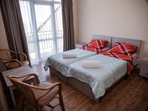 a bedroom with a bed and a large window at Green Garden Hotel in Makhinjauri