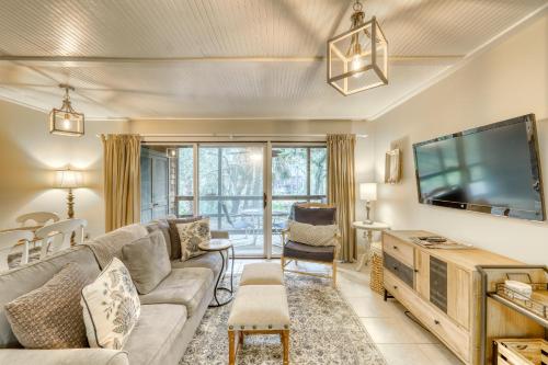 a living room with a couch and a flat screen tv at Mariner's Watch 4250 in Kiawah Island