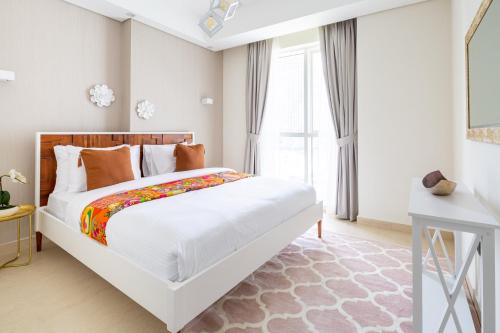 a bedroom with a large white bed and a window at Frank Porter - Mon Reve in Dubai