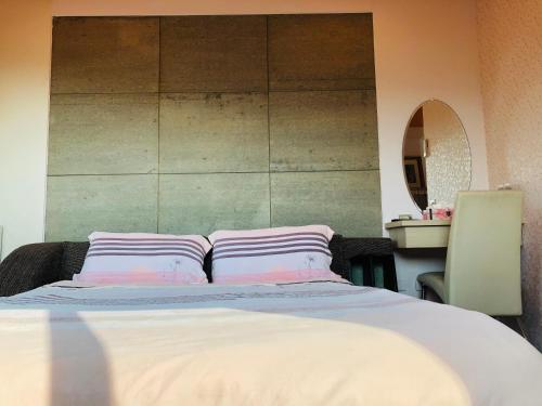 a bedroom with a bed with two pillows on it at Chong Er Ya She Homestay in Jiji