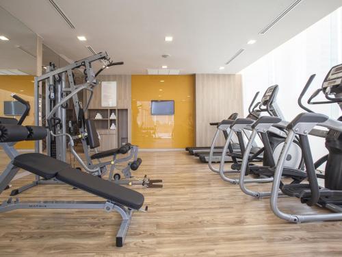 a row of treadmills and ellipticals in a gym at Mercure Pattaya Ocean Resort - SHA Extra Plus in Pattaya