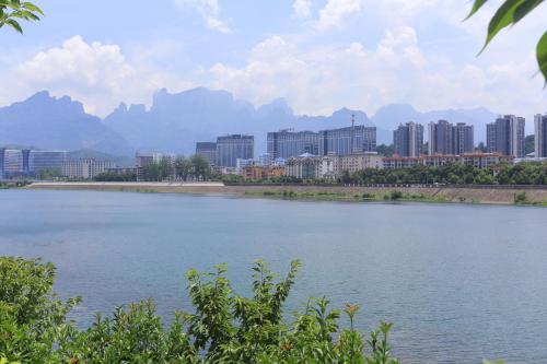 a large body of water in front of a city at Sky Gate Guesthouse-English Speaking Hostess, Family friendly,2-minute walk to Entrance of Tianmen Mount ,Free pick up service,Book attraction tickets, Free Laundry,Private Tour in Zhangjiajie