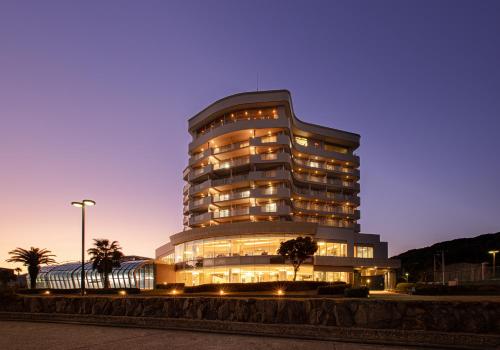 a large building with many windows at night at The Gran Resort Elegante Awajishima in Awaji