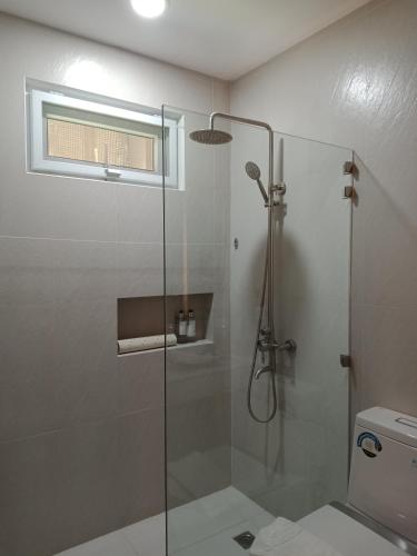 a bathroom with a glass shower with a toilet at Ciabel Hotel and Fitness Center in San Juan