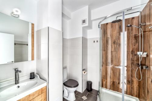 a bathroom with a shower and a toilet and a sink at Cloud Studio in Sibiu