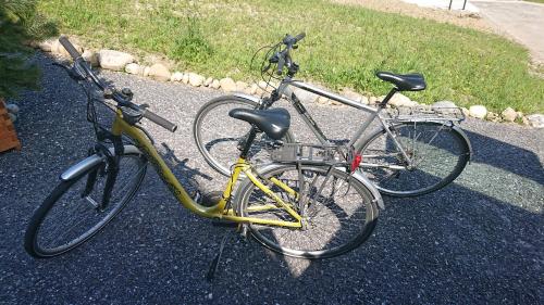 two bikes parked next to each other on the street at Studio à la campagne au bout du lac d'Annecy in Doussard