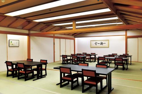a large room with tables and chairs in it at The Gran Resort Princess Arima in Kobe