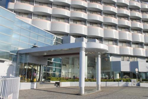 an external view of a building with a glass facade at The Gran Resort Princess Arima in Kobe