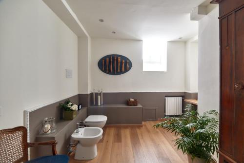 a bathroom with two toilets and a sink at L' Hôtellerie Easy Suites in Palermo