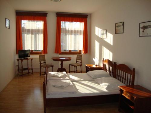 A bed or beds in a room at Penzion Aviatik